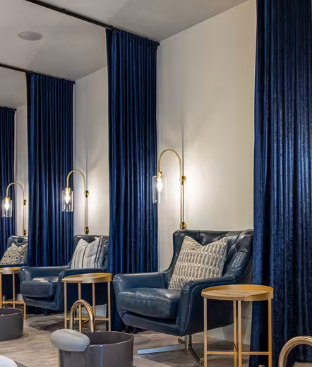Pedicure chairs with navy curtains in the Pedi & Mane spa